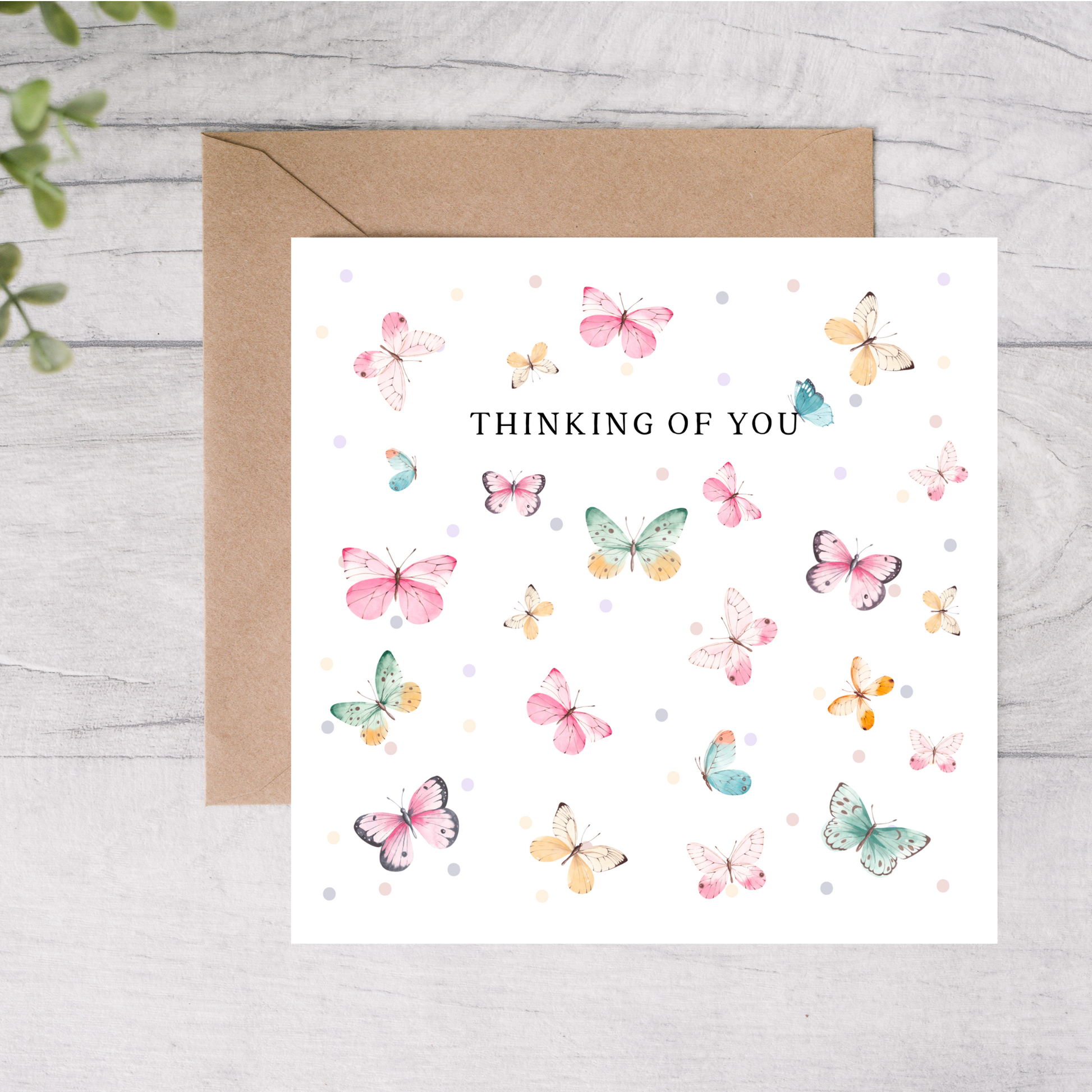 Greeting card with colorful butterflies and 'Thinking of You' text on a white background