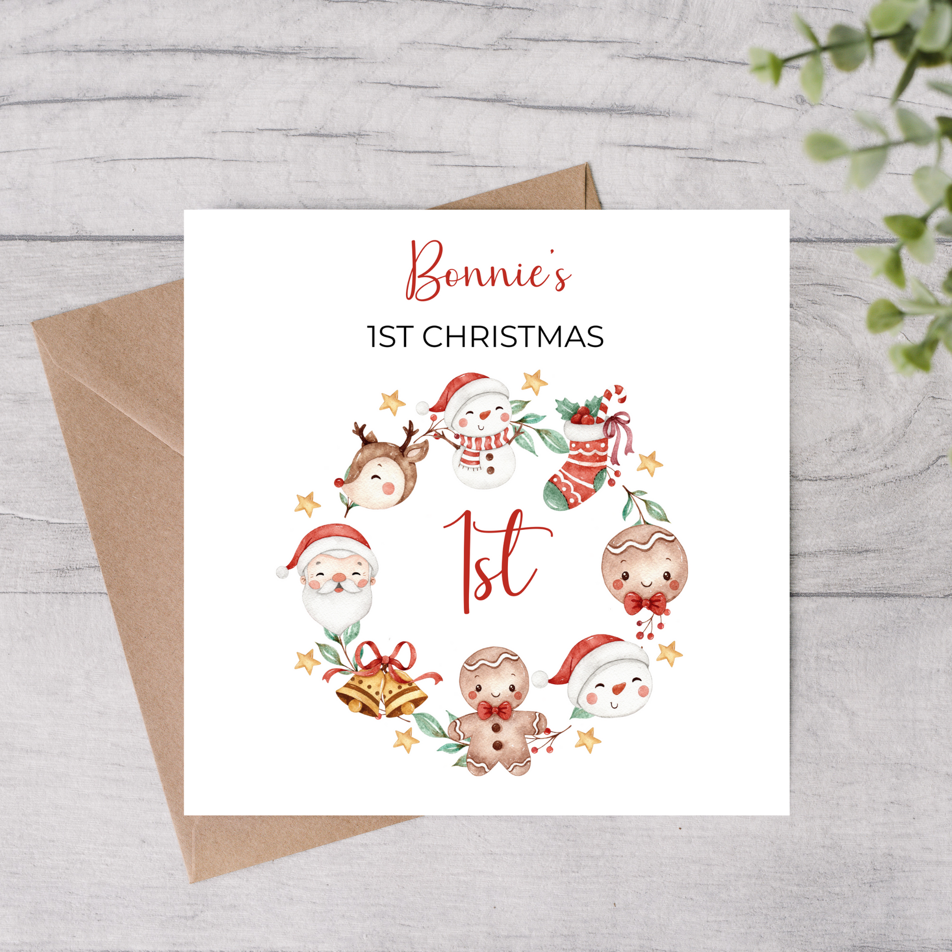 Christmas-themed card for a baby's first Christmas with cartoon characters and 'Bonnie's 1st Christmas' text on a wooden surface.