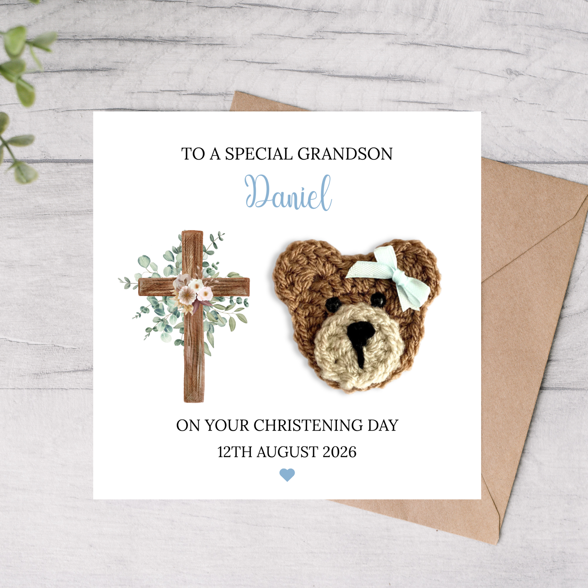 Personalized grandson christening card with teddy bear  and cross, on a light gray background.